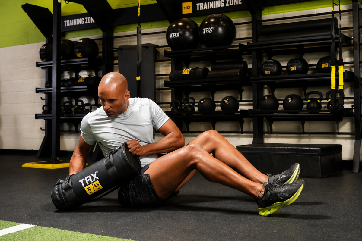 Functional training exercises performed with TRX Suspension Trainer, kettlebells, and dumbbells in a home gym setup.