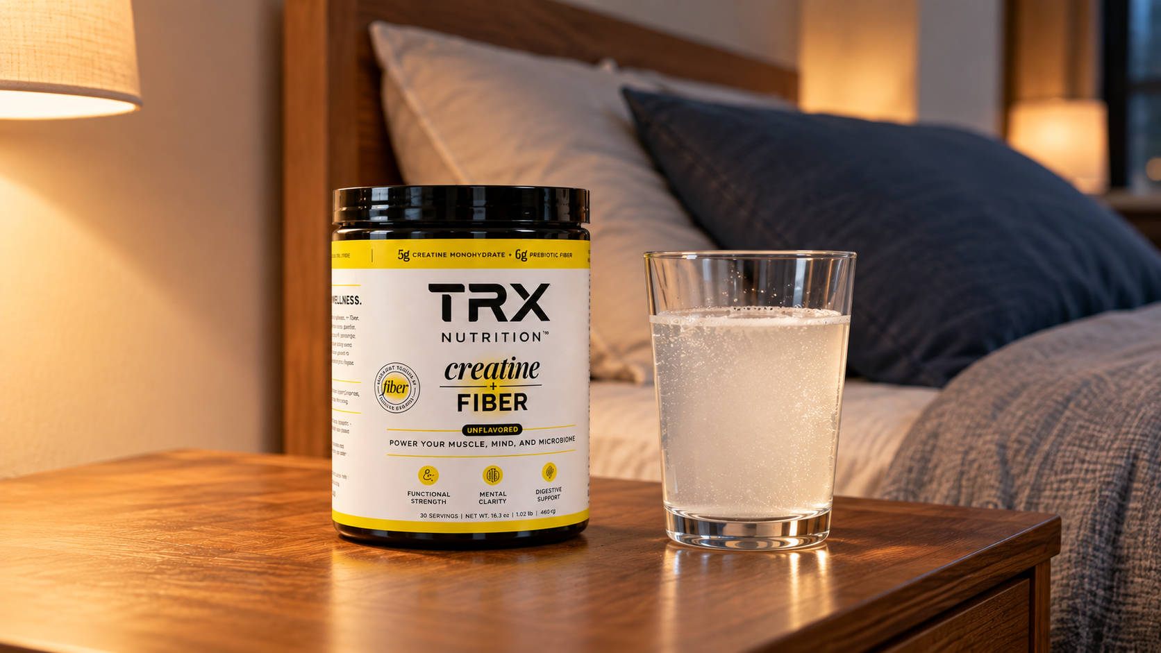 Creatine before bed beside a glass of water on a nightstand