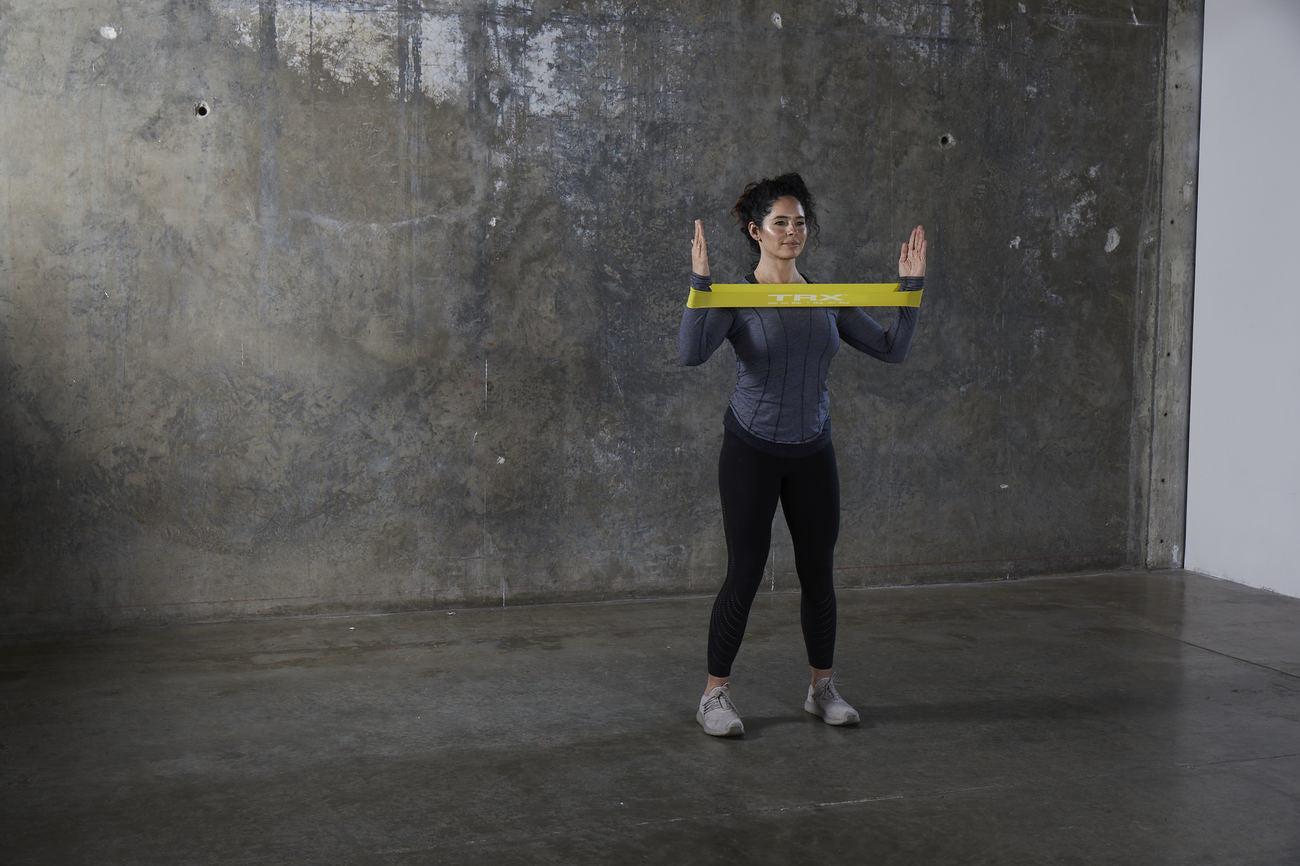 Female trainer doing resistance band upper body workout