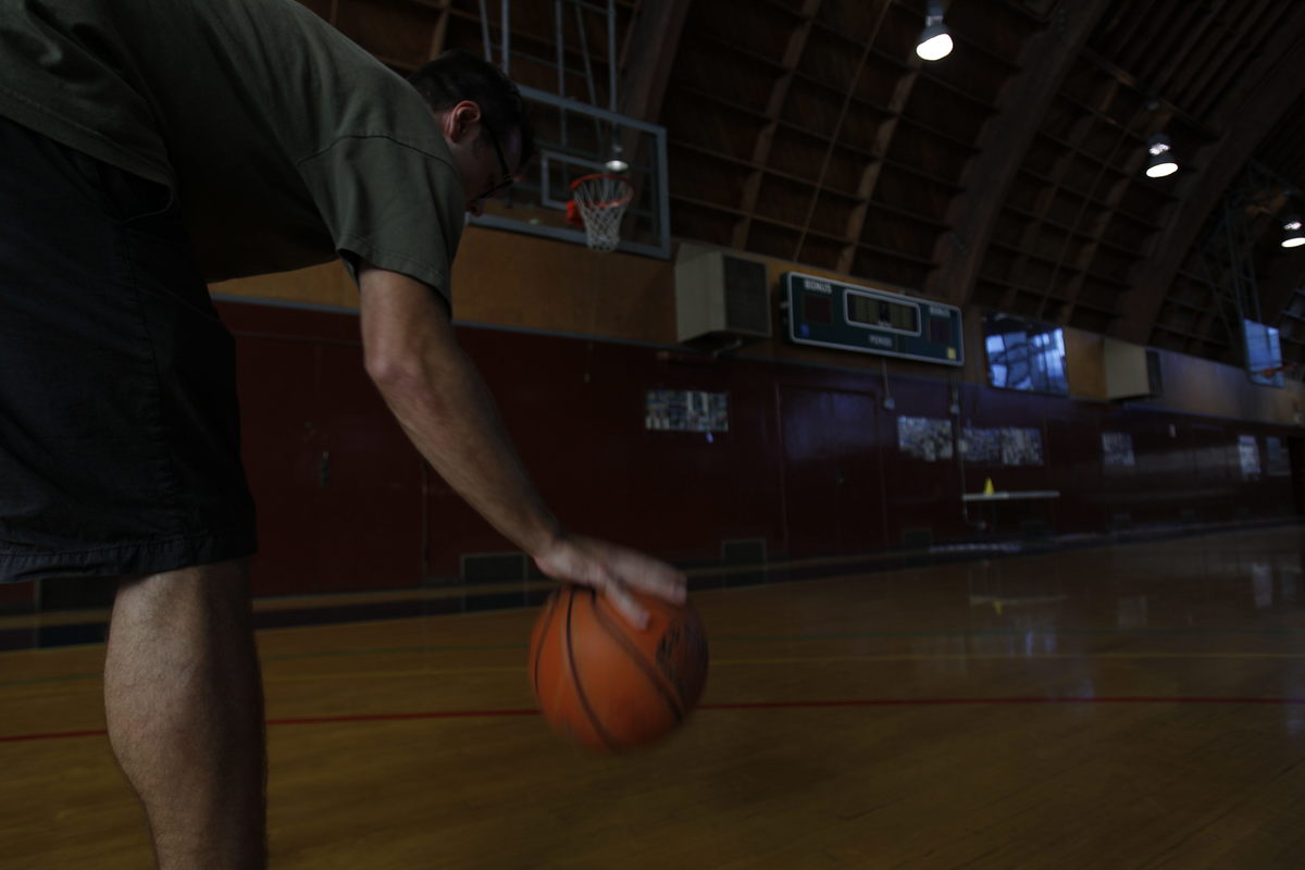 man practicing basketball exercises