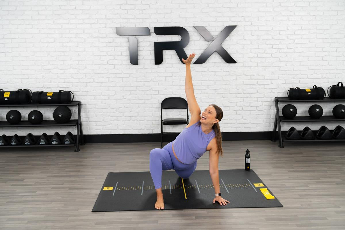 trx trainer doing prenatal yoga poses