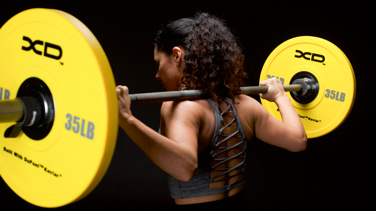 woman doing barbell squats