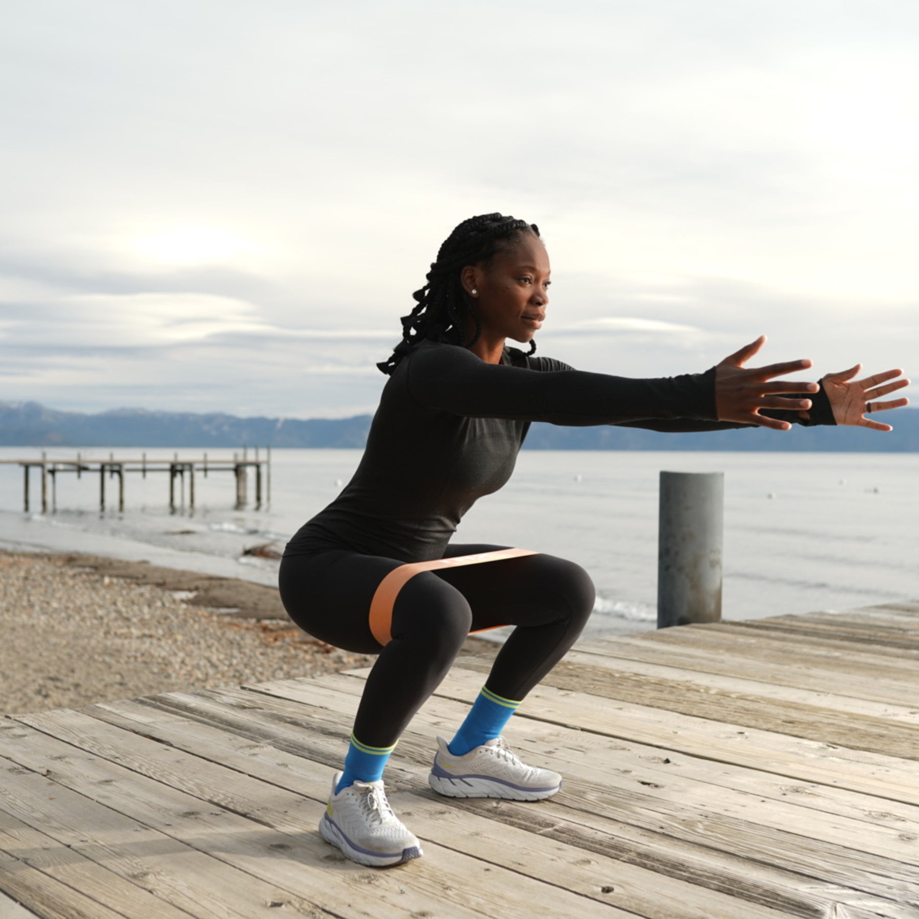 trainer using exercise bands to squat