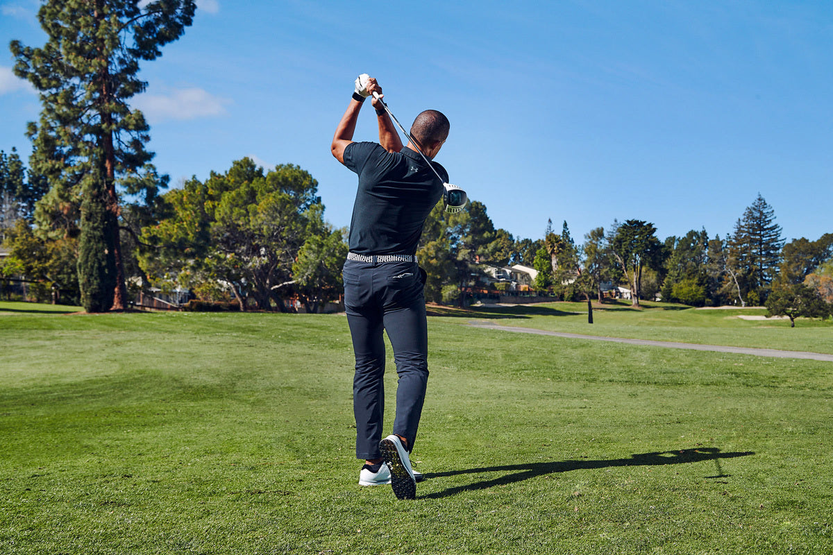 TA Anderson finishes his golf swing on a golf course. 