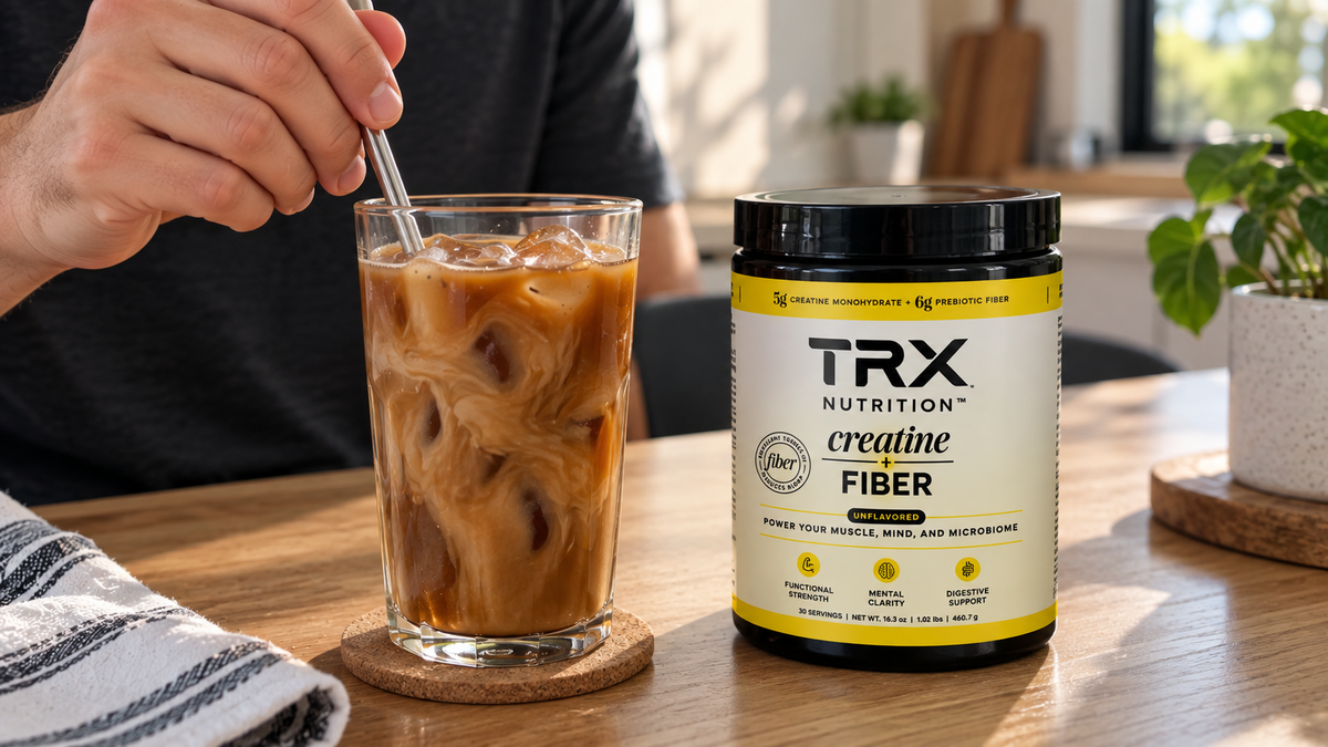 Mixing creatine with coffee beside a TRX Nutrition™ Creatine + Fiber tub