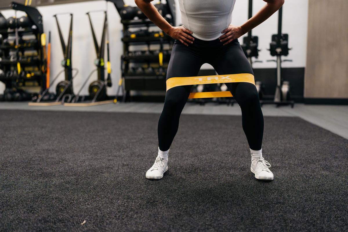 resistance band squats with a TRX resistance band