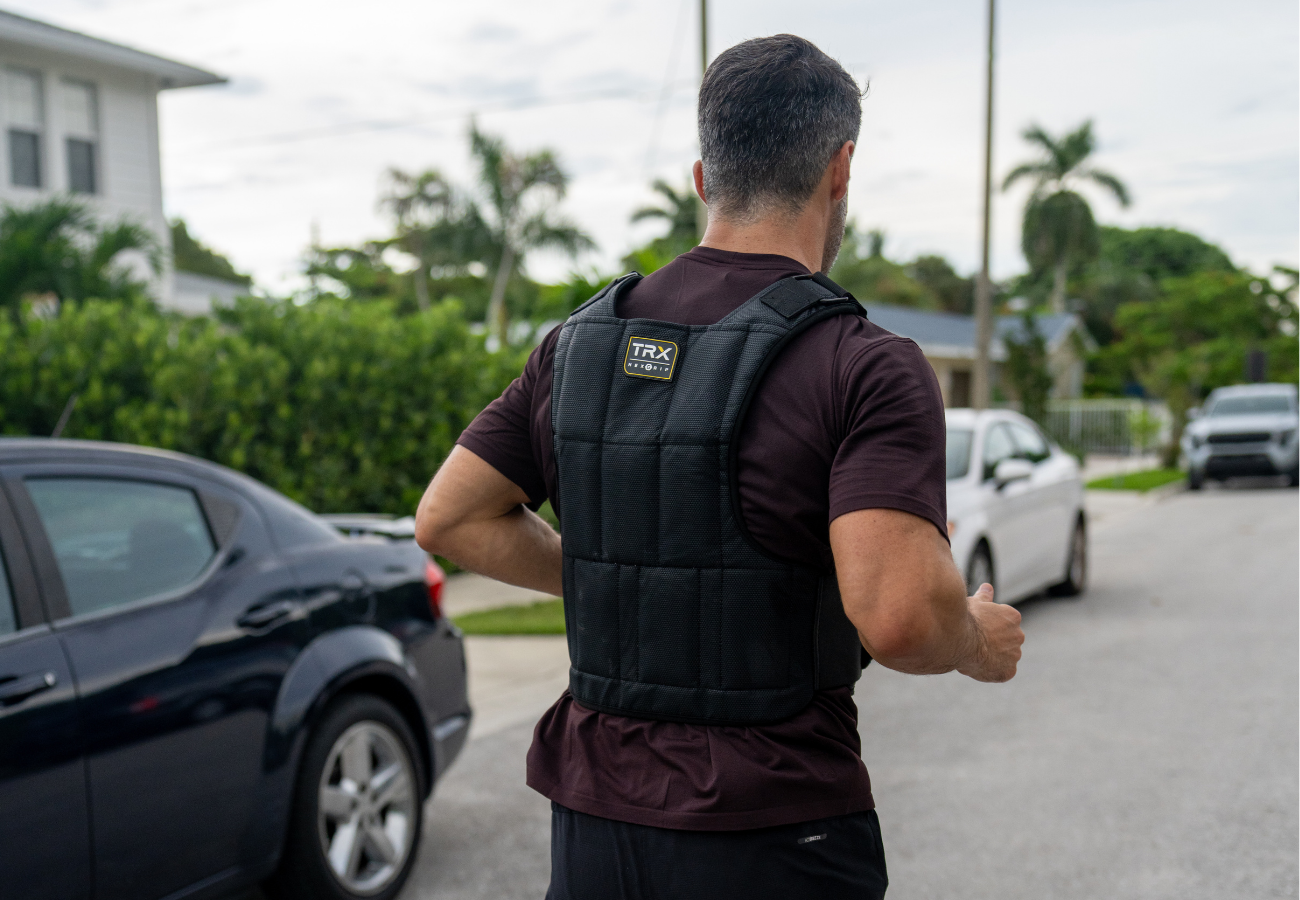 Trainer using TRX weighted vest during zone 2 training run