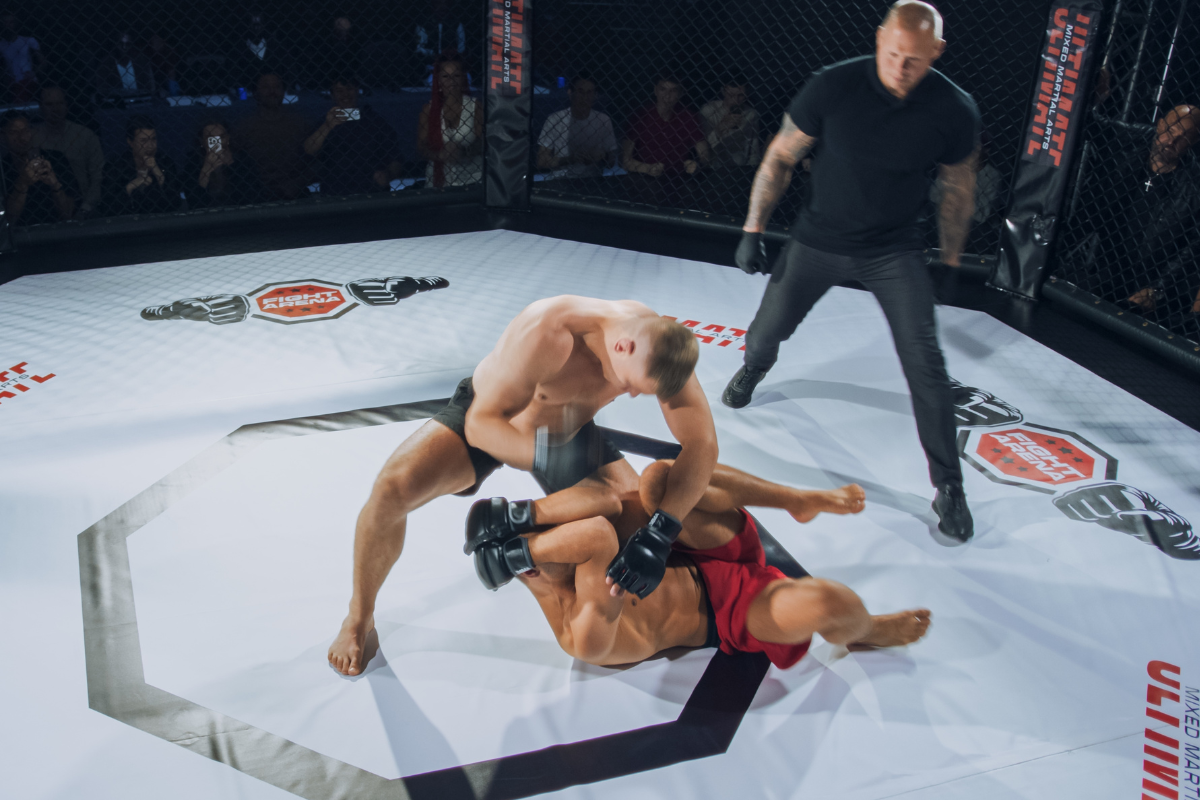 MMA fighter performing TRX MMA workout with suspension straps and rotational training equipment