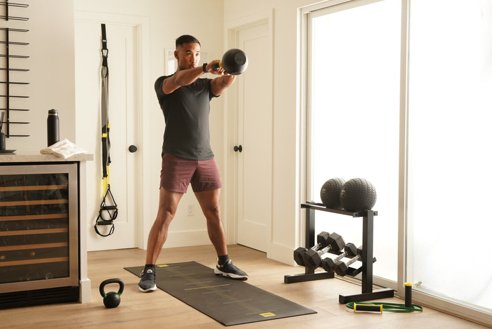 trainer doing kettlebell swings