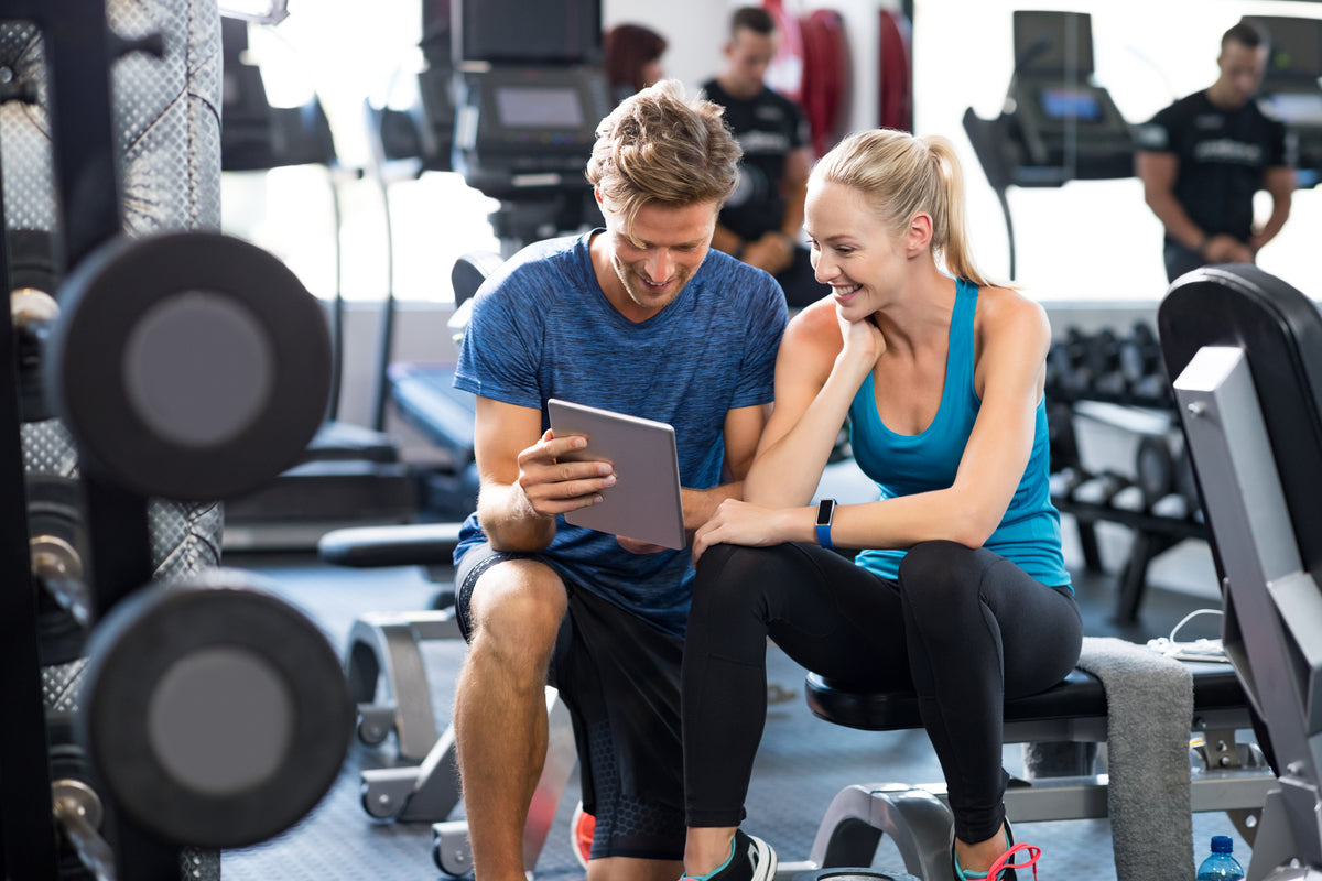 trainer helping client with fitness