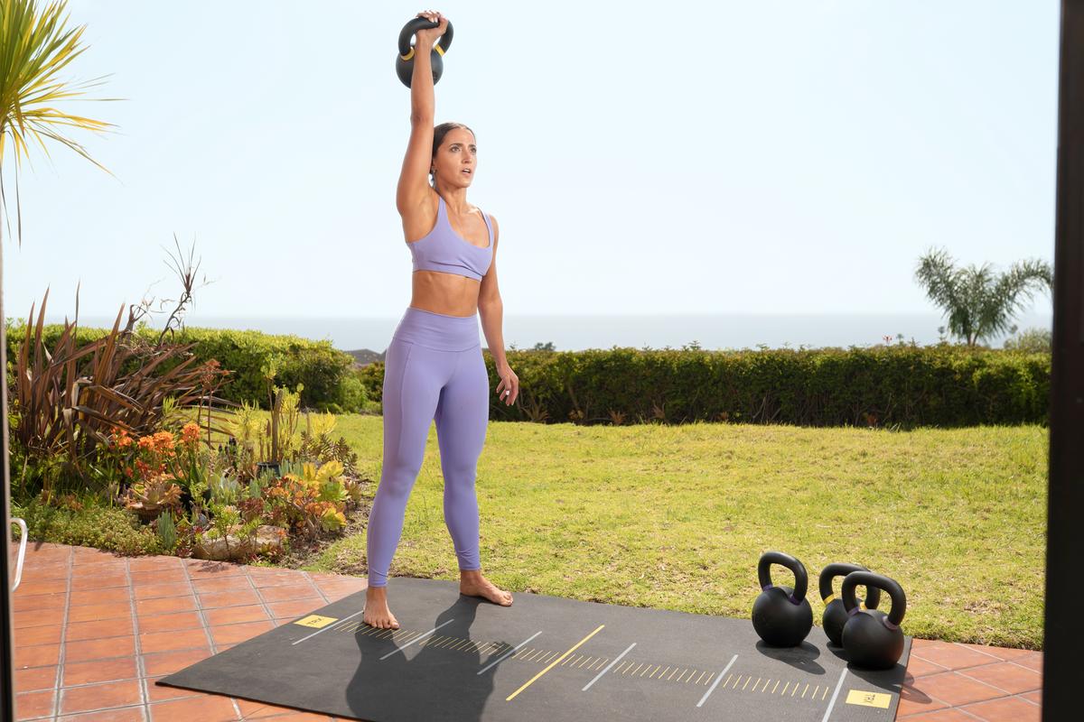 trainer using kettlebell to exercise